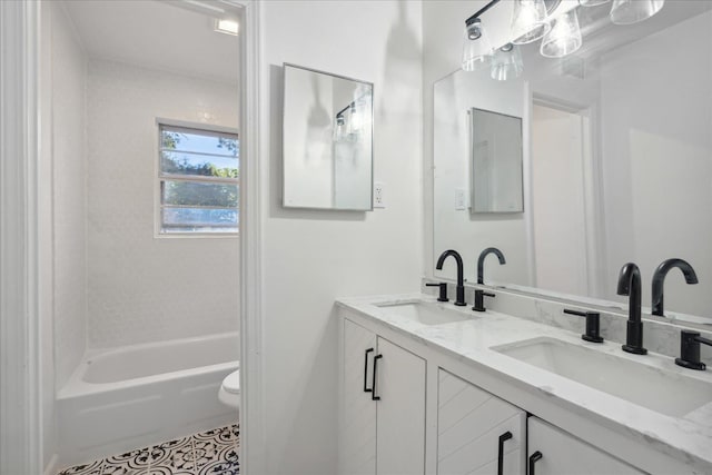 full bathroom featuring vanity, toilet, tiled shower / bath combo, and tile patterned flooring