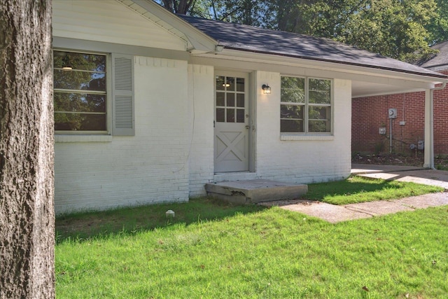 doorway to property featuring a yard