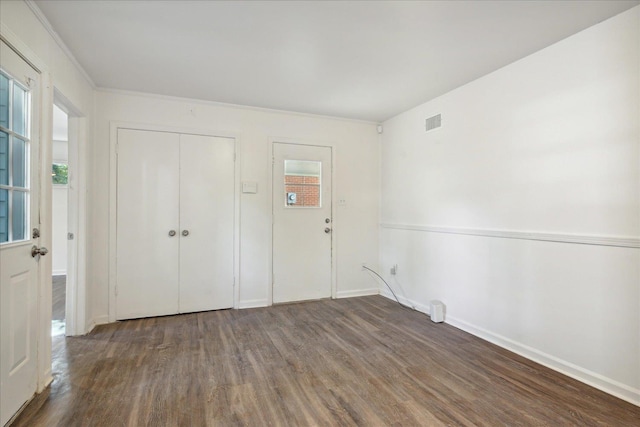 interior space with dark hardwood / wood-style flooring and a closet