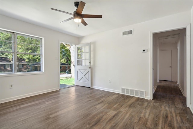 empty room featuring dark wood-type flooring and ceiling fan