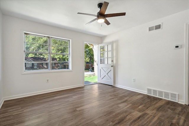 spare room with dark hardwood / wood-style floors and ceiling fan