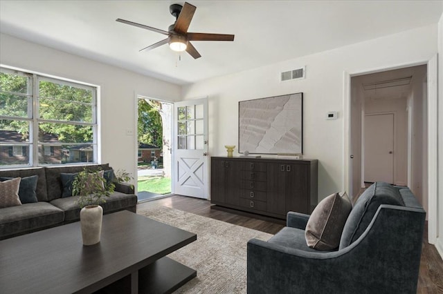 living room with ceiling fan and dark hardwood / wood-style floors