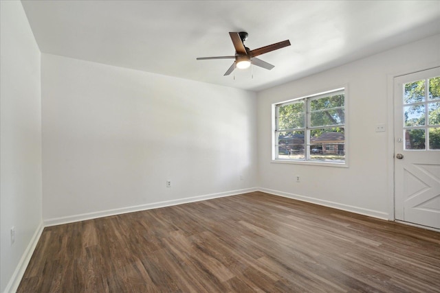 spare room featuring dark wood-type flooring and ceiling fan