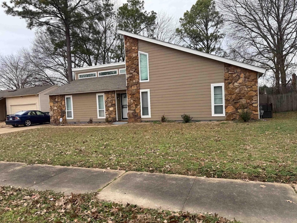 view of front of home featuring a garage and a front lawn