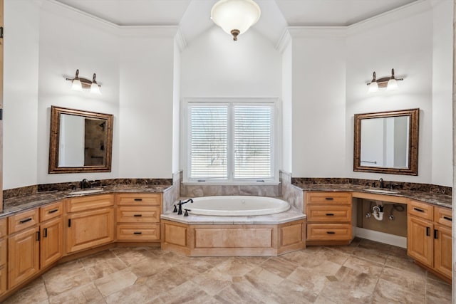 bathroom featuring ornamental molding, tiled bath, and vanity