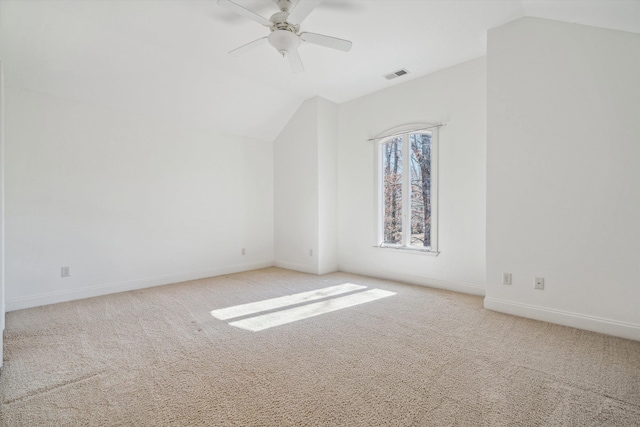 additional living space with vaulted ceiling, light colored carpet, and ceiling fan