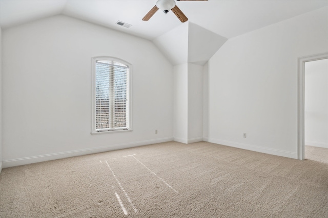 interior space featuring vaulted ceiling, light colored carpet, and ceiling fan