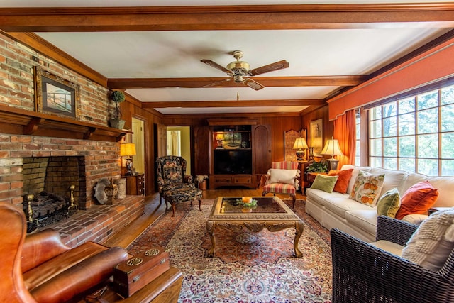 living room with a brick fireplace, beam ceiling, hardwood / wood-style floors, and wood walls