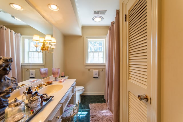 bathroom with a chandelier, vanity, toilet, crown molding, and tile patterned floors