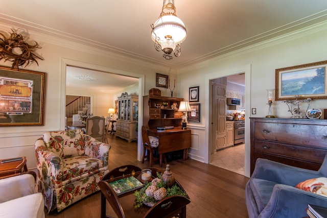 living room with ornamental molding and light hardwood / wood-style flooring