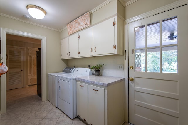 washroom featuring washer and dryer, crown molding, and cabinets