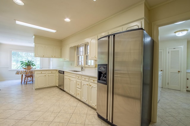 kitchen with sink, appliances with stainless steel finishes, tasteful backsplash, ornamental molding, and light tile patterned flooring