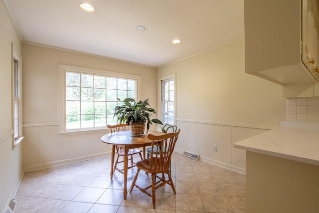 tiled dining area with crown molding