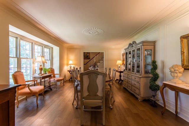 sitting room with dark wood-type flooring and ornamental molding