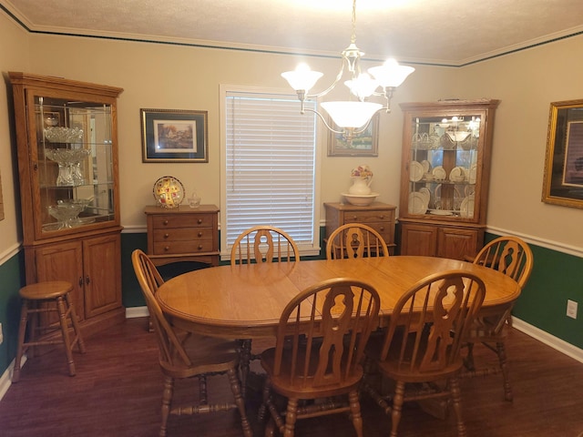 dining space with a notable chandelier, ornamental molding, and dark hardwood / wood-style floors