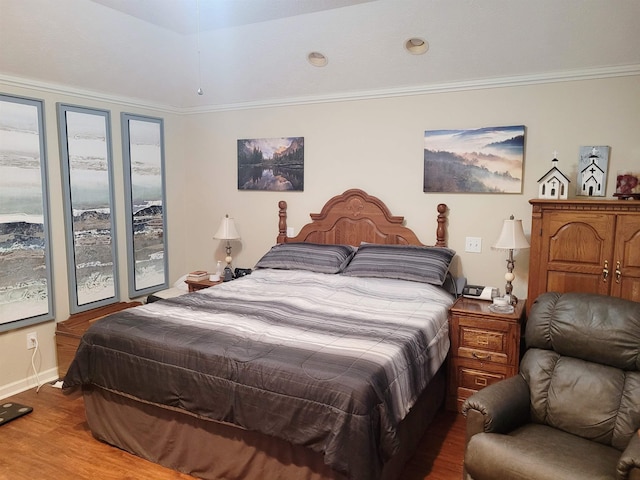 bedroom featuring wood-type flooring and ornamental molding