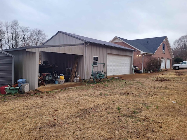 garage with a yard and a carport