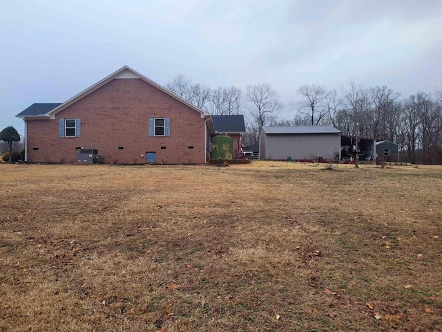 view of side of property with a yard