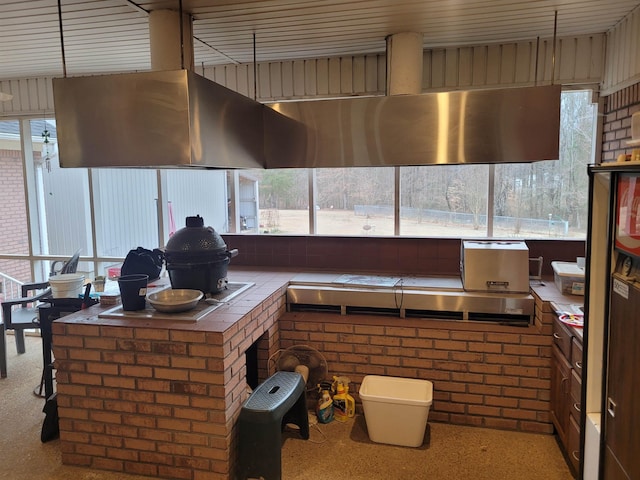 kitchen featuring ventilation hood and tile countertops