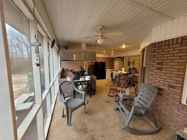 sunroom with ceiling fan and wood ceiling