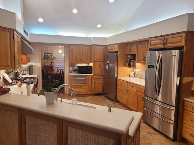 kitchen with stainless steel fridge, sink, and decorative backsplash