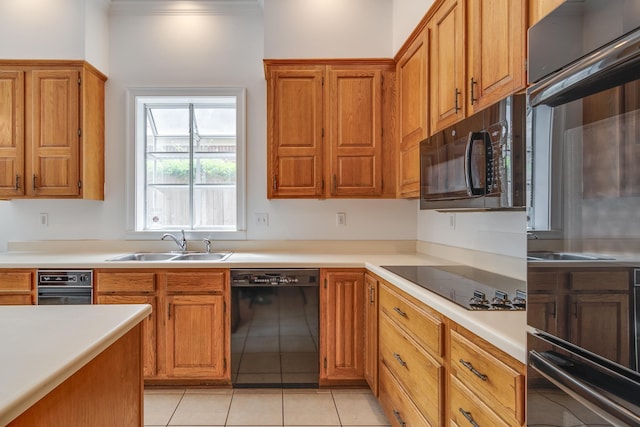 kitchen with brown cabinets, light countertops, and black appliances