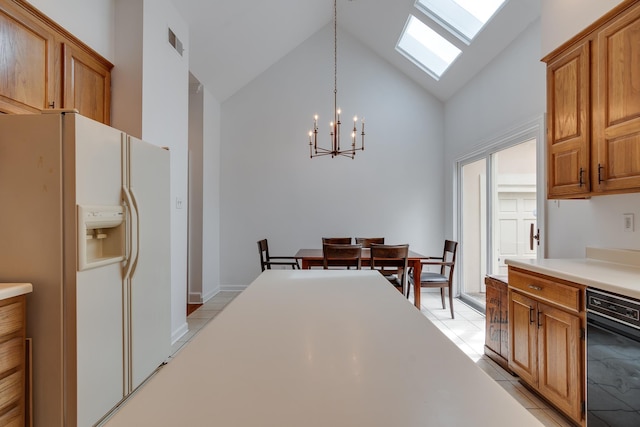 kitchen with white refrigerator with ice dispenser, light countertops, hanging light fixtures, visible vents, and high vaulted ceiling