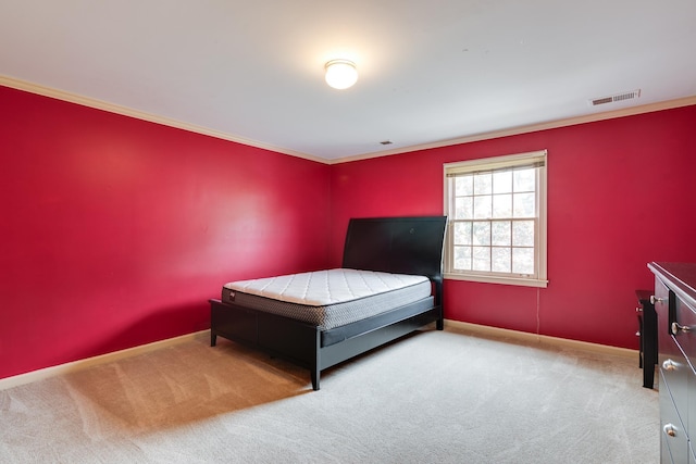 unfurnished bedroom with baseboards, visible vents, crown molding, and carpet flooring