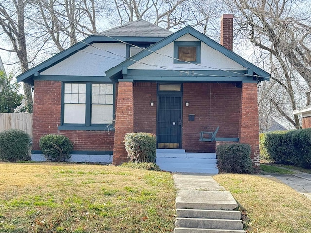 bungalow-style house featuring a front lawn