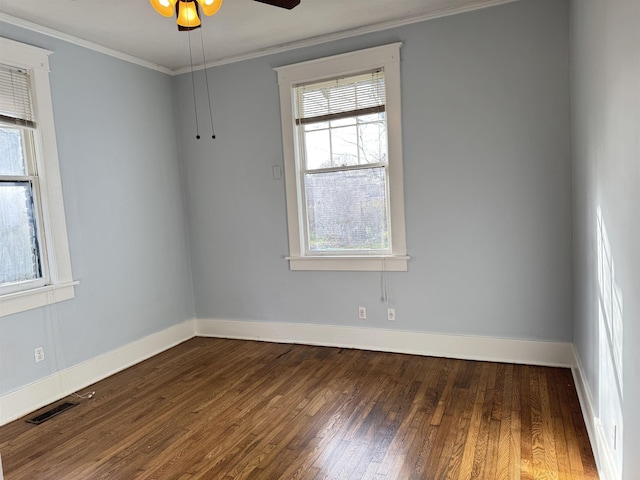 empty room with ornamental molding, dark hardwood / wood-style floors, and ceiling fan