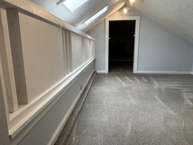 additional living space featuring vaulted ceiling and carpet flooring