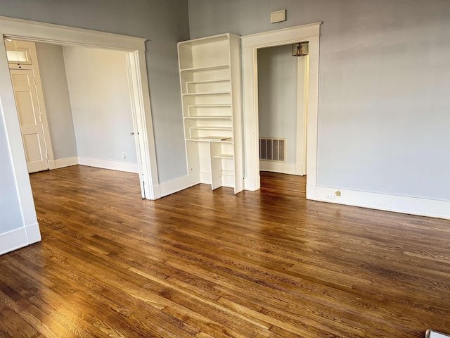 unfurnished room featuring dark hardwood / wood-style flooring