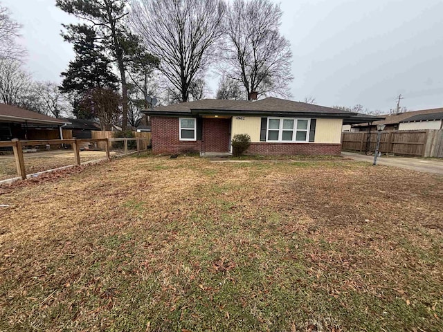 view of front of house with a carport and a front lawn