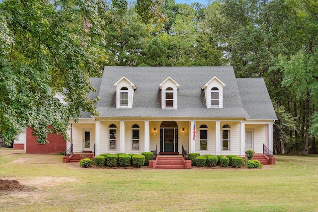 cape cod house featuring covered porch and a front lawn