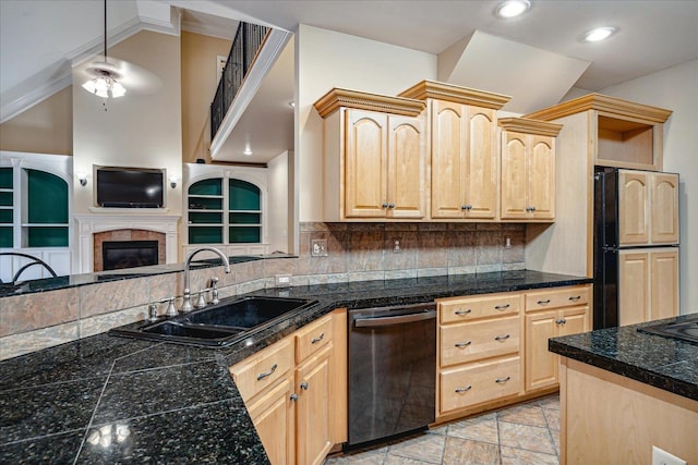 kitchen with dishwashing machine, sink, a tile fireplace, decorative backsplash, and light brown cabinets