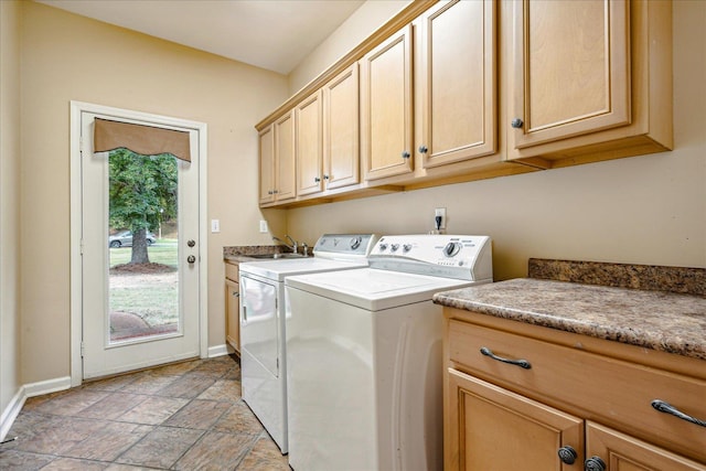 washroom featuring cabinets and washer and dryer