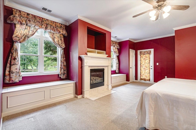 unfurnished bedroom with light colored carpet, ornamental molding, a tile fireplace, and ceiling fan