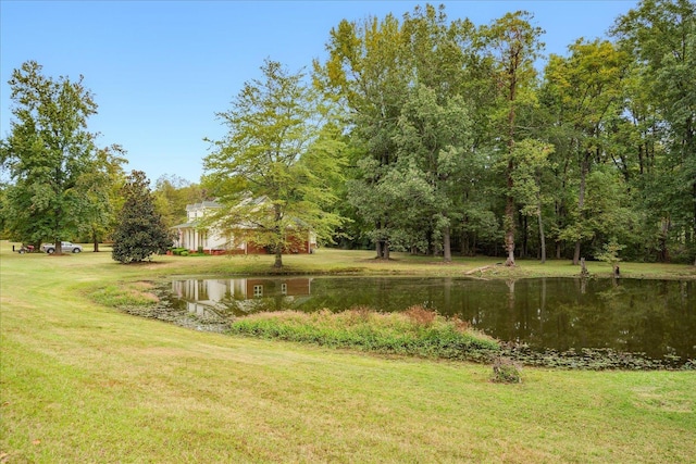 view of community with a water view and a lawn