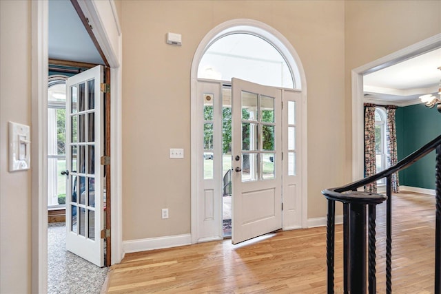 foyer with an inviting chandelier and light hardwood / wood-style floors