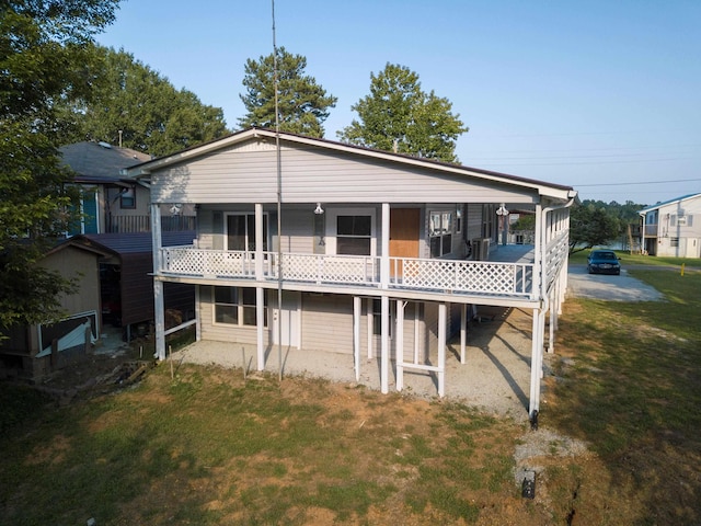 rear view of house featuring a yard