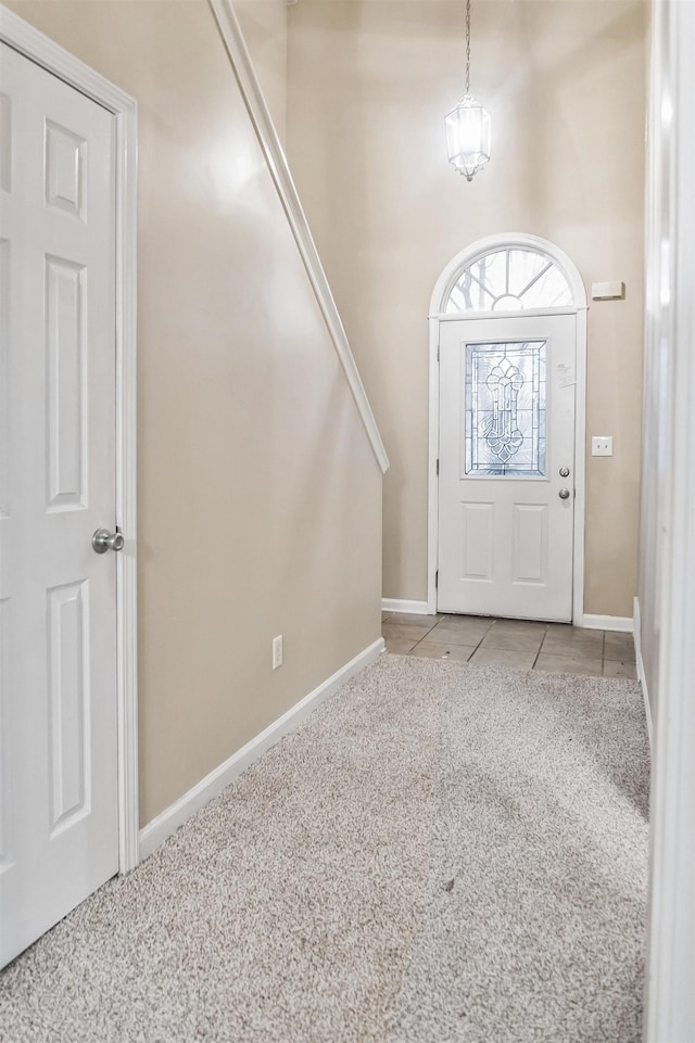 foyer entrance with light colored carpet