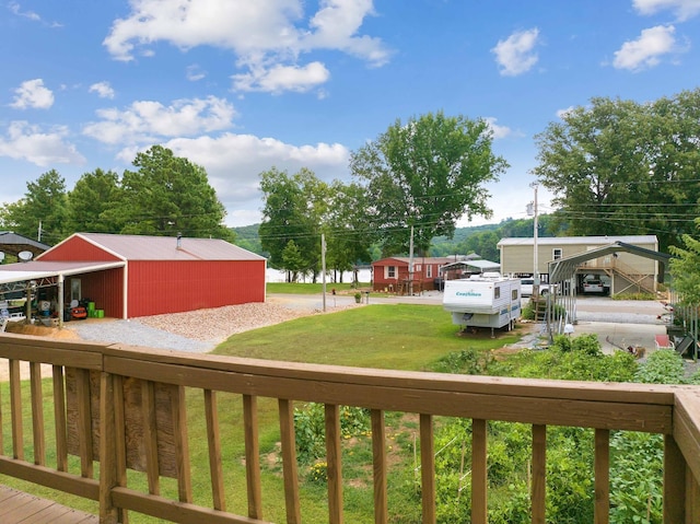 deck featuring a yard and a carport