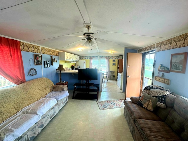 living room featuring vaulted ceiling and ceiling fan