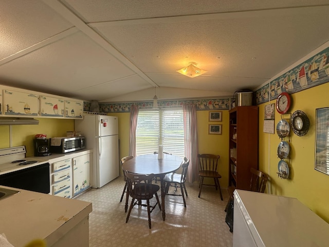 dining area featuring vaulted ceiling