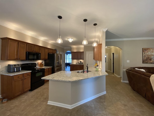 kitchen featuring sink, hanging light fixtures, ornamental molding, light stone counters, and black appliances