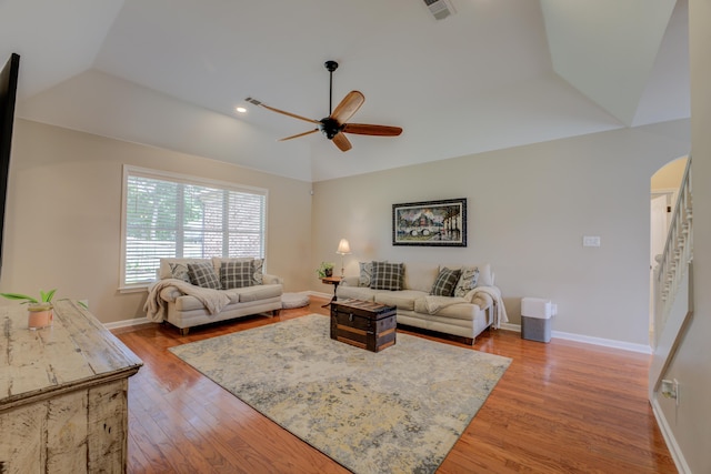 living room with lofted ceiling, hardwood / wood-style floors, and ceiling fan