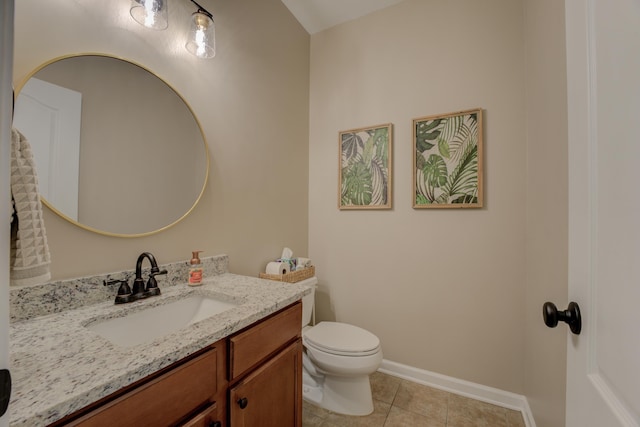 bathroom featuring vanity, tile patterned floors, and toilet