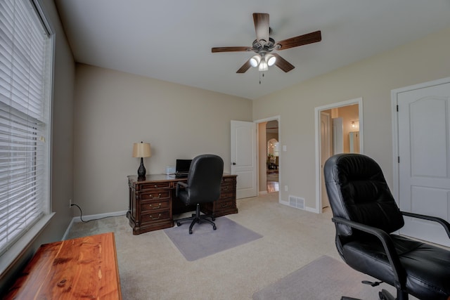 office area featuring ceiling fan and light carpet