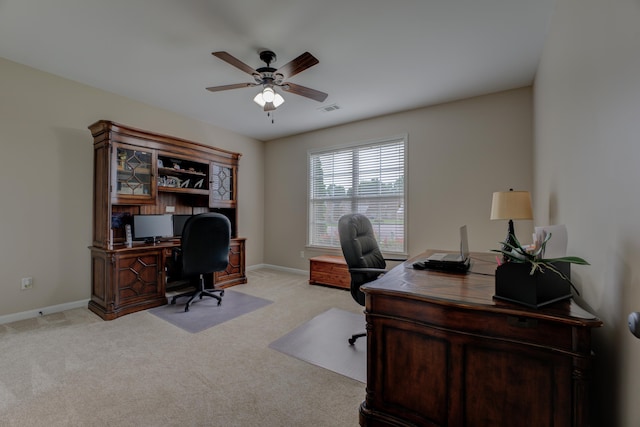 home office featuring light carpet and ceiling fan