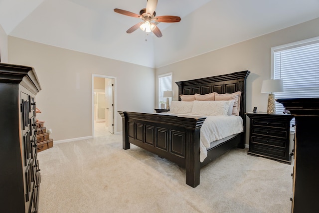 carpeted bedroom with vaulted ceiling, ensuite bathroom, and ceiling fan